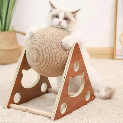 Cat playing with a ball on a wooden cat scratcher toy